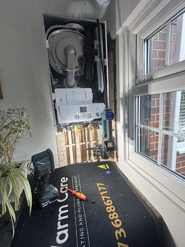 Warm Care engineer repairing a boiler on site